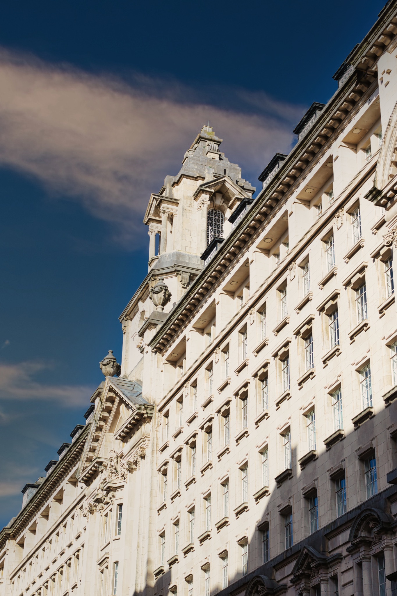 Exterior of a Tall White Building with Windows in Manchester, UK.